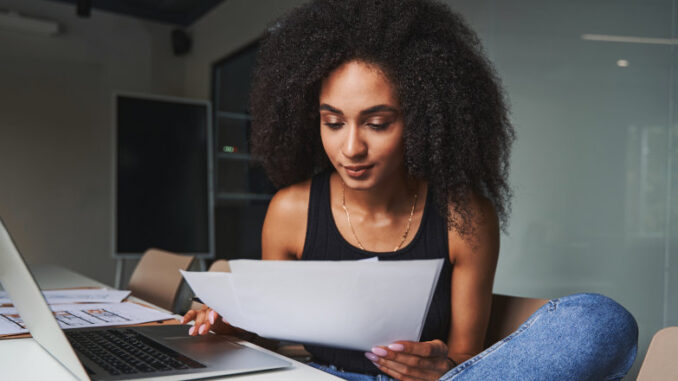 Calm HR manager working with new CVs of employees